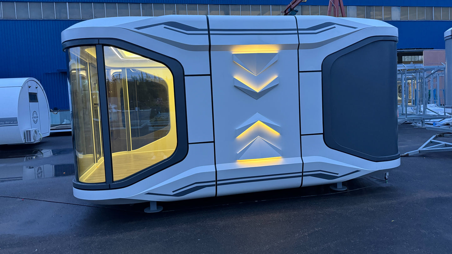 Modern, futuristic-looking SX-1 Lite Space
Capsule pod with an illuminated design on a wet after-rain pavement.