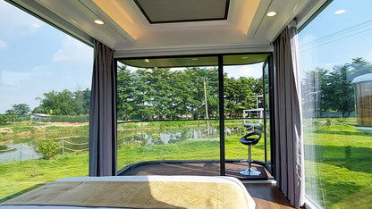 Modern Space Capsule SX-3 Vista interior with large windows offering a view of greenery outside