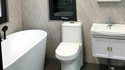 Bathroom in sx-2 flow space capsule modular pod with white freestanding bathtub, toilet, and sink against a tiled wall.