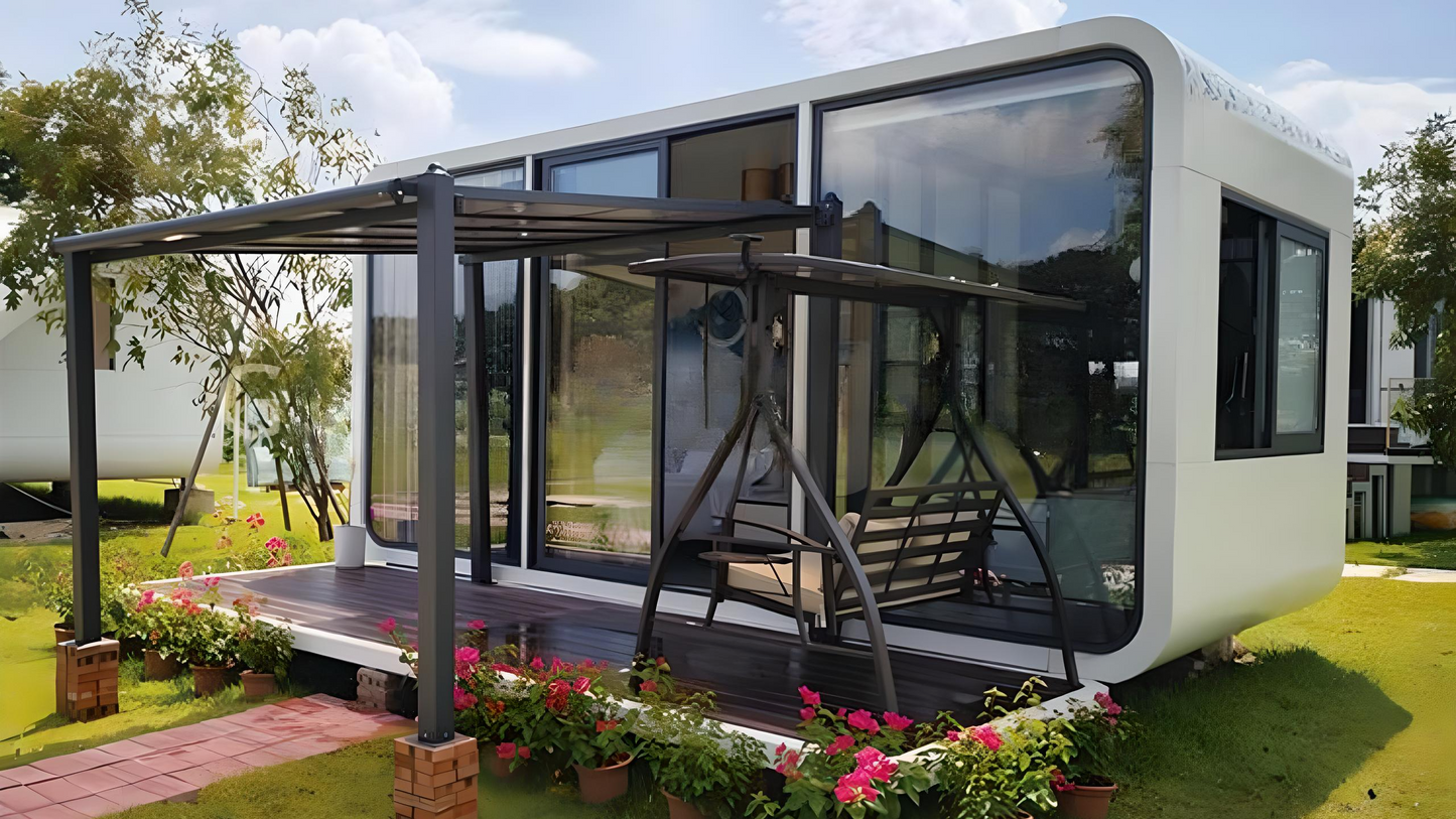 Modern modular AP-1 Compact Apple Cabin with large windows on a grassy area