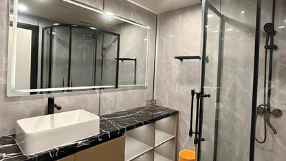 Modern bathroom inside SX-3 Vista space Cpsule modular pod with a vanity, mirror, and shower area.