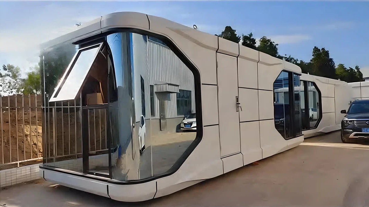 Modern, futuristic-looking modular hospitality unit SX-2 Flow space capsule with large glass windows on a clear day.
