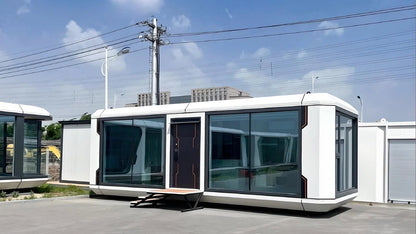 Modern modular Apple Cabin AP-2 Balanced on a clear day with power lines in the background