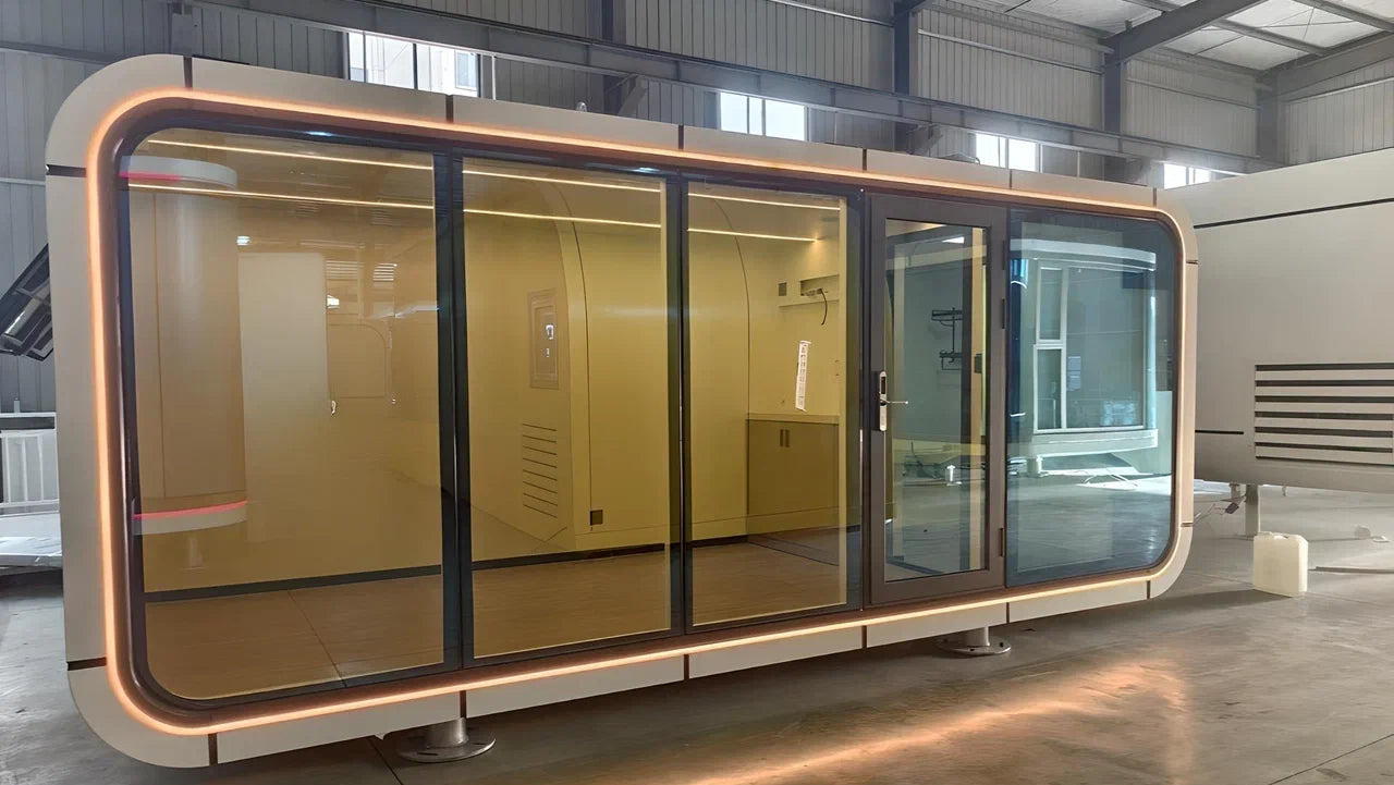 Modern glass AP-2 Balanced Apple Cabin pod in a warehouse setting