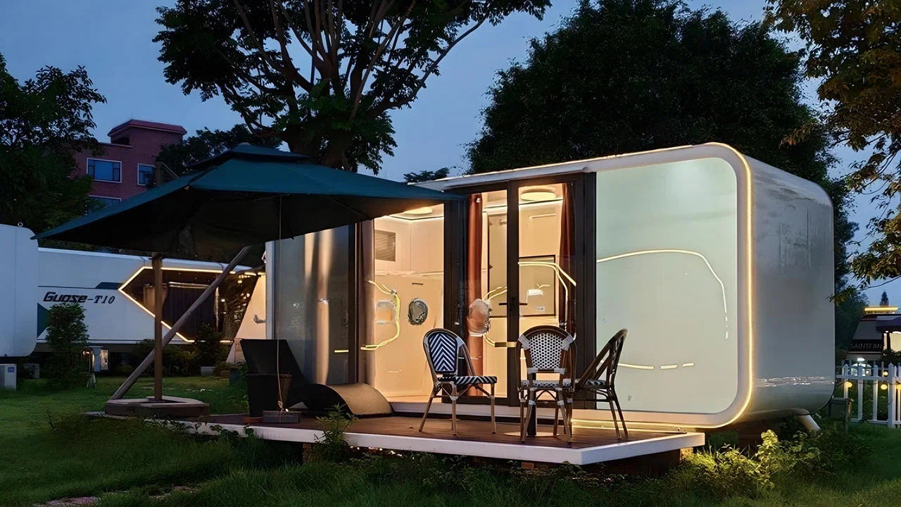 Modern modular compact Apple Cabin with outdoor seating area at night