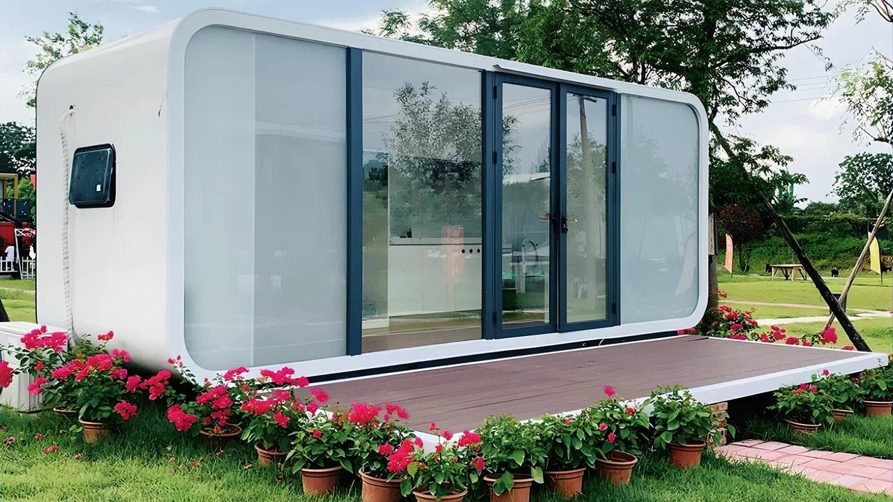 Modern prefabricated Applec Cabin compact size with a garden and flowers around it