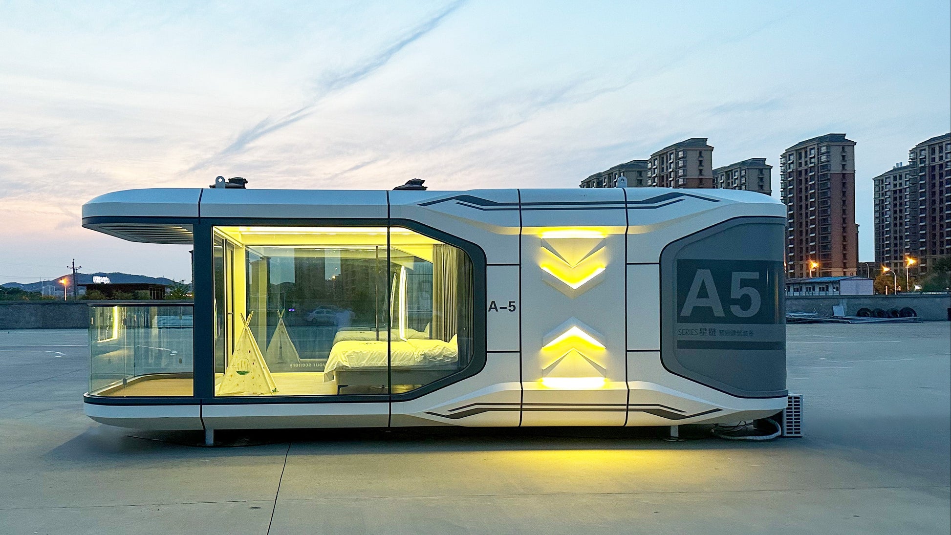Modern prefab SX-2 flow space capsule cabin with full glass front and ambient lighting, premium Airbnb-ready unit designed for glamping businesses and luxury outdoor rentals
