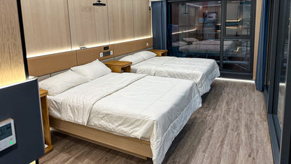 Modern bedroom with two beds and wooden flooring in AP-2 Balanced Apple Cabin